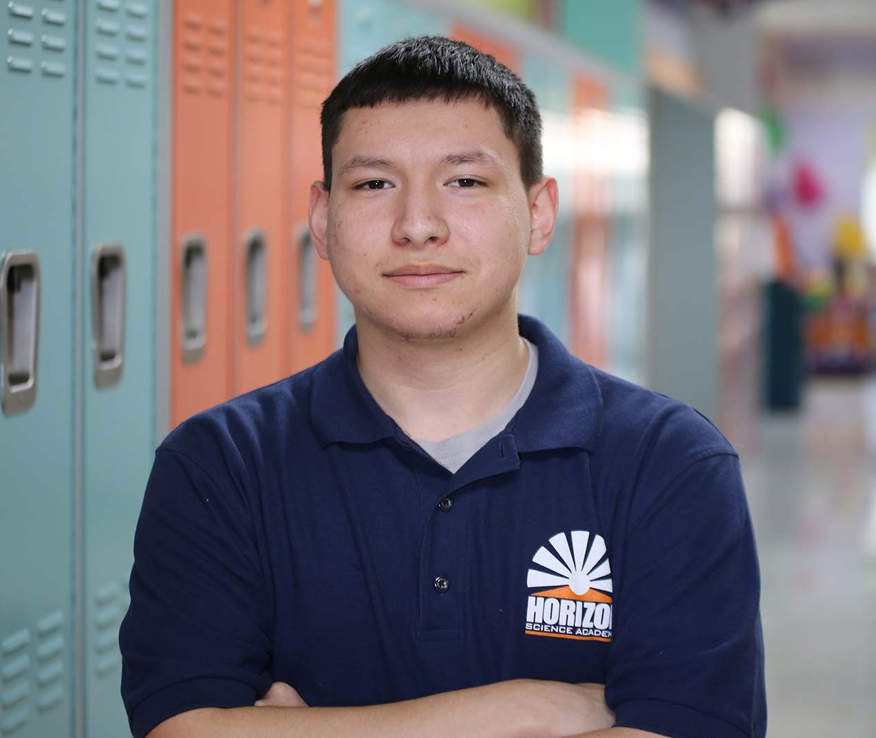 Student working on a notebook in a classroom.
