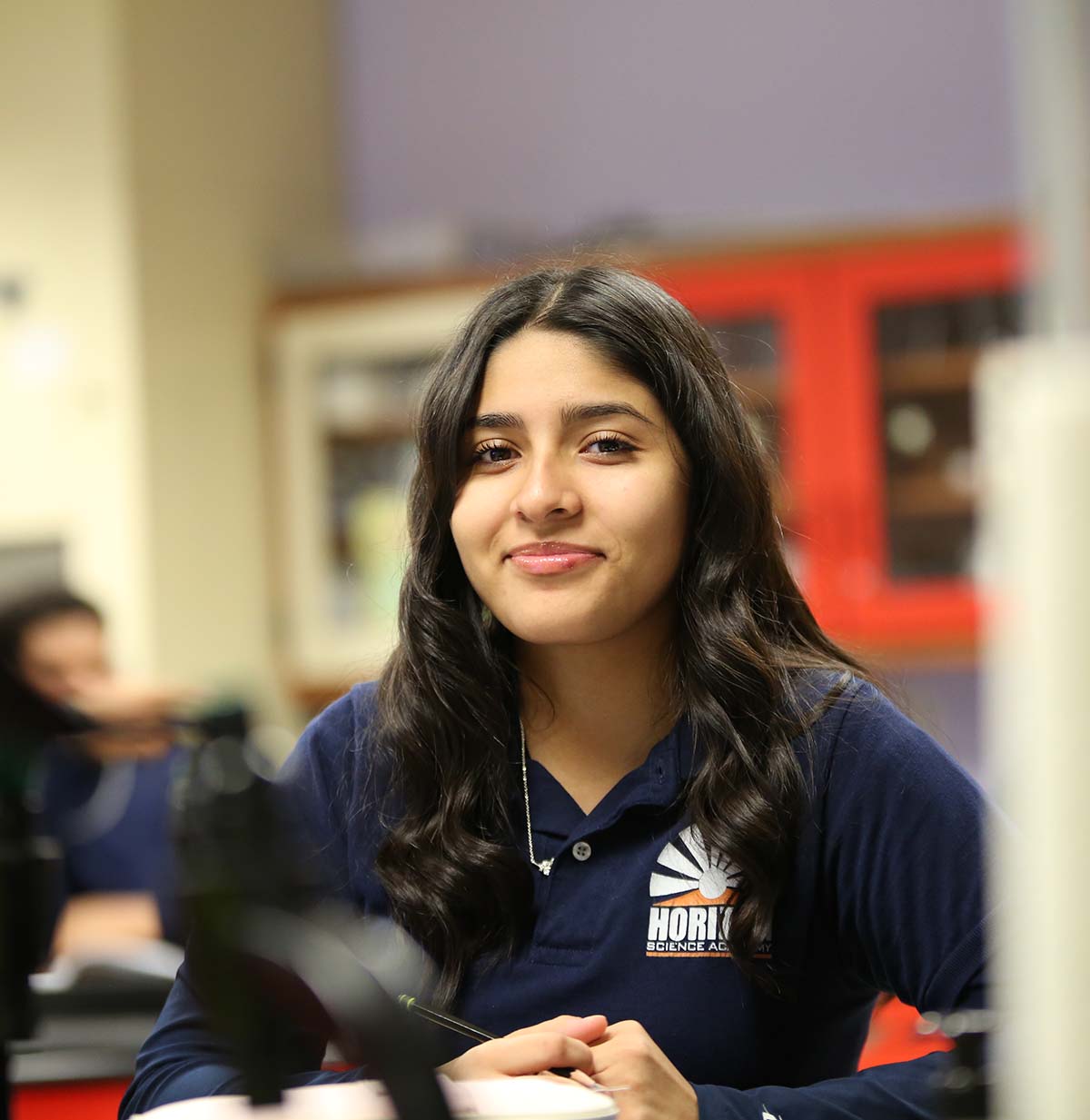 Student drawing in a classroom.